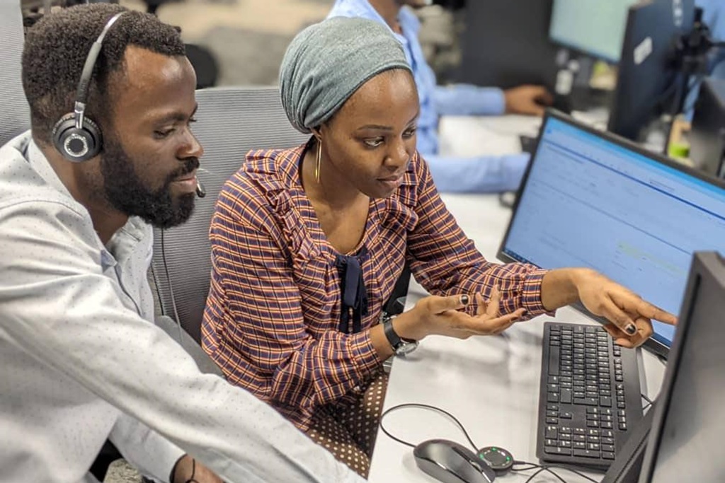 Serious diverse programmers using tablet